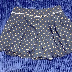 Very cute navy blue skort with tan/ cream polka dots.